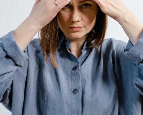 Woman thinking about choosing between Skin Tightening vs. Facelift